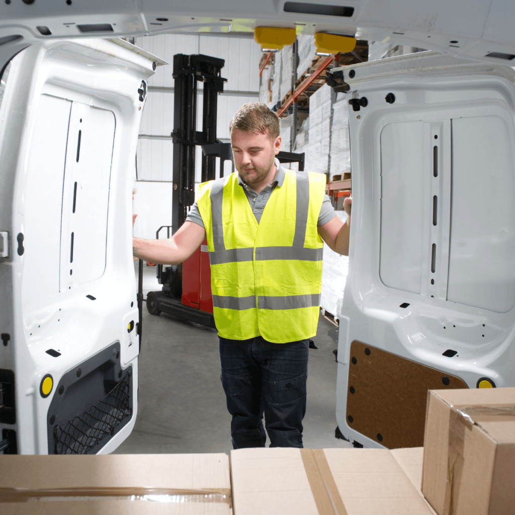 Part Time worker in a high vis jacket closing a van door