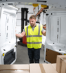 Part Time worker in a high vis jacket closing a van door