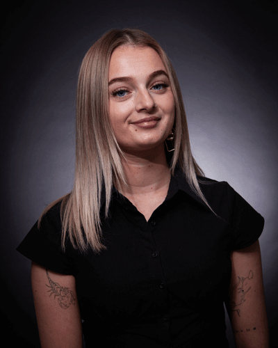 Portrait photo of Katie ~Harding wearing a black short sleeved shirt