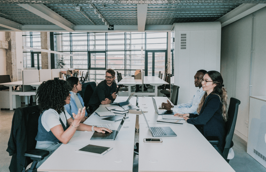 NI Increase: People sat around a desk talking 