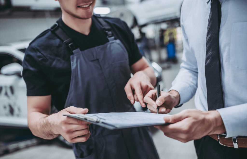 Vehicle Technican and manager holding a clipboard