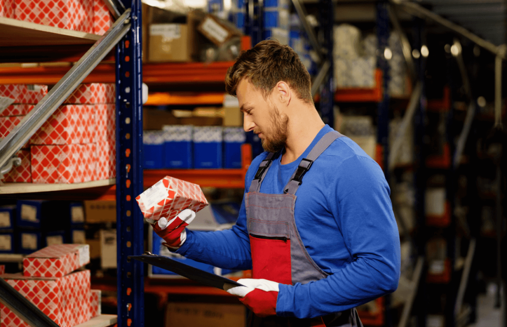 Vehicle Technician looking at car parts in a storage room
