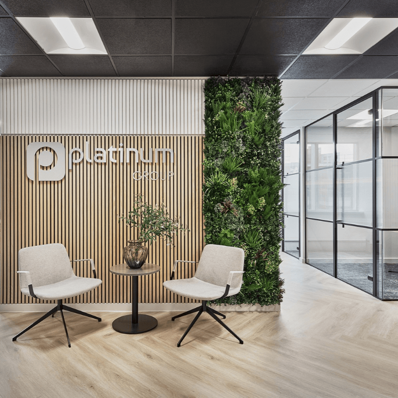 Photo of two chairs beneath the platinum employment logo in the office entrance.